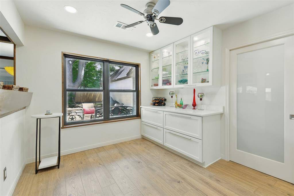 The breakfast room showcases a butlers pantry with quartz counters and deep drawers, a ceiling fan and recessed lighting.