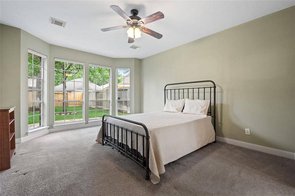 Primary suite with lots of natural light overlooking the backyard