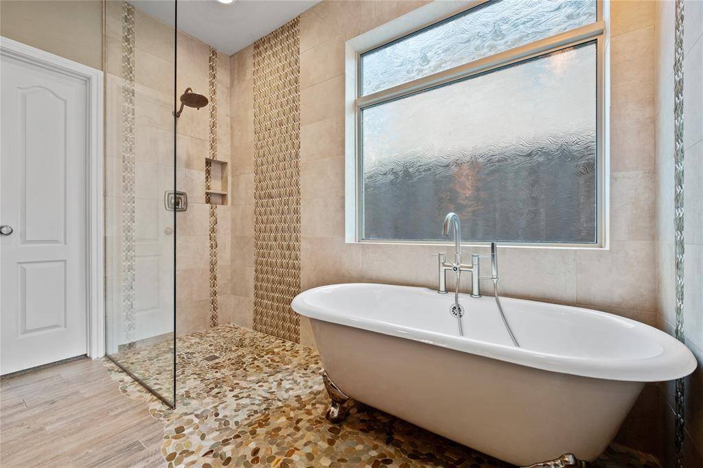 Primary bathroom boast soaking tub and shower