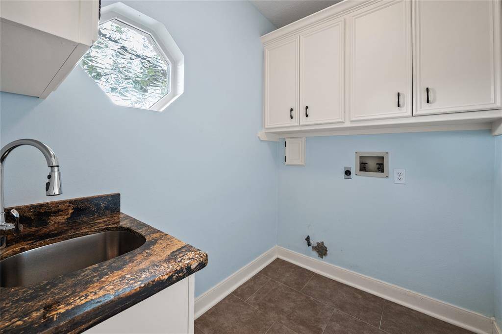 Laundry room is large with added sink and additional storage