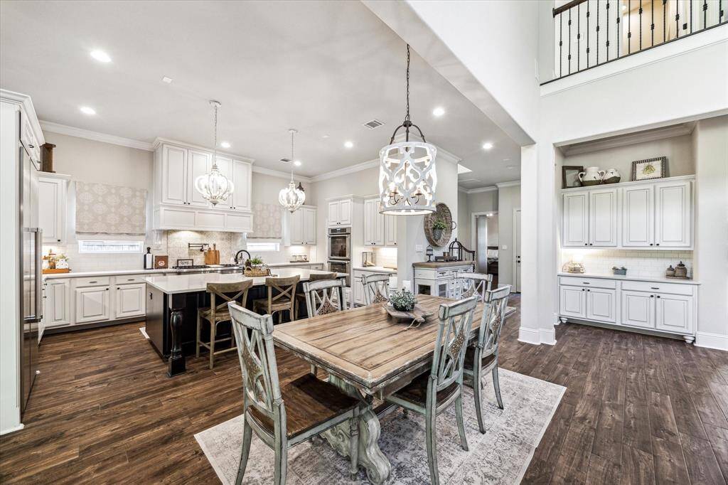 Enjoy Saturday morning pancakes and Wednesday night lasagna in this bright and open casual dining area, featuring stylish overhead lighting and a convenient serving bar just steps away. With additional seating at the island and the formal dining room nearby, there’s always room to gather with family and friends.