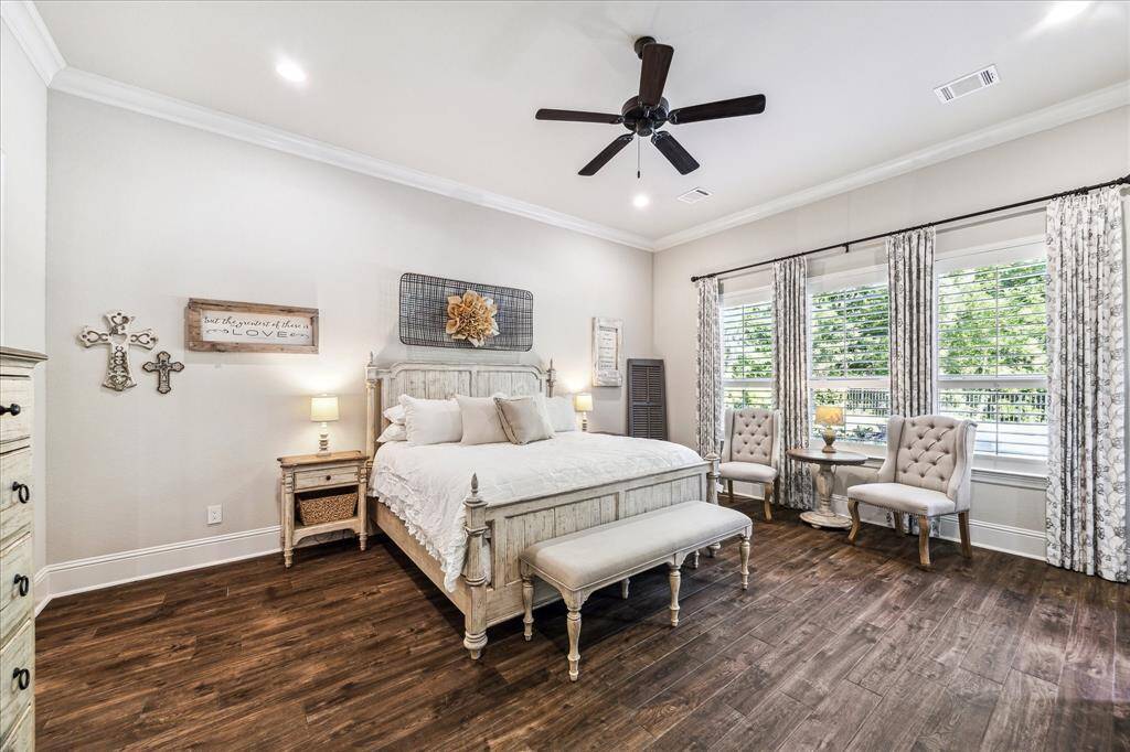 You’ll have sweet dreams in this posh owner’s retreat, styled with soft neutral finishes and ample space for your California king and other large furnishings. A glass door provides direct access to the pool and patio for effortless indoor-outdoor enjoyment, while a luxurious spa-like ensuite and private bonus room offer the perfect place to relax and recharge.
