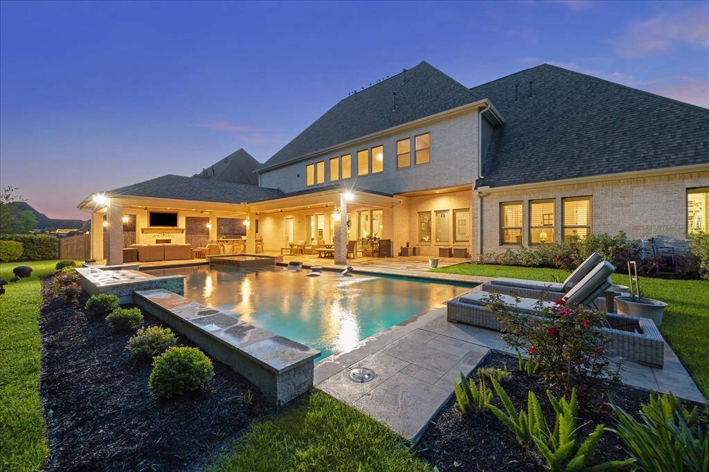 Step into your own private paradise, where a heated and chilled pool with water features and ambient lighting sets the stage for year-round enjoyment. The luxurious covered patio boasts a full summer kitchen and cozy fireplace, creating the ultimate space for entertaining or relaxing in style. With no back neighbors and a peaceful wooded backdrop, this outdoor retreat is as private as it is picturesque.