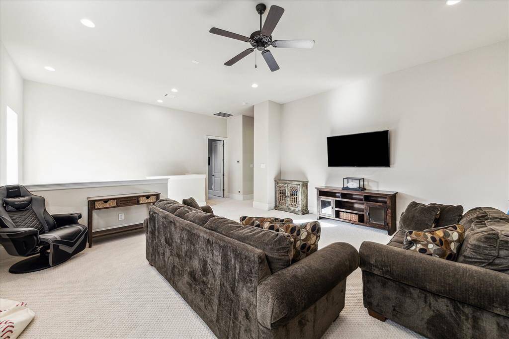 Whether it’s movie night, game day, or just a casual hangout, this spacious upstairs game room is ready for it all. With soft neutral tones, plush carpet, recessed lighting, and a ceiling fan for added comfort, it’s the perfect place to relax, play, and unwind.
