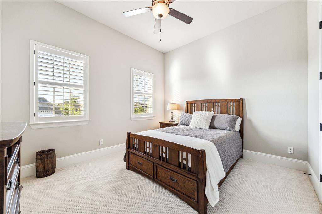 Your family and guests will rest comfortably in this welcoming bedroom with upgraded carpet, neutral paint, wood-shuttered windows, a cooling fan, large closet and ensuite access to a full bathroom.