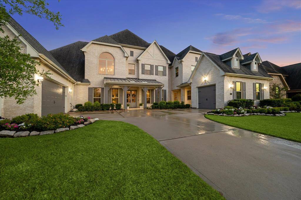 Receive a warm welcome home every time with this stunning curb appeal, where a timeless a brick elevation meets thoughtful design. From the charming covered front porch to the manicured lawn and split three-car garage, every detail invites you to come in, unwind, and feel right at home.
