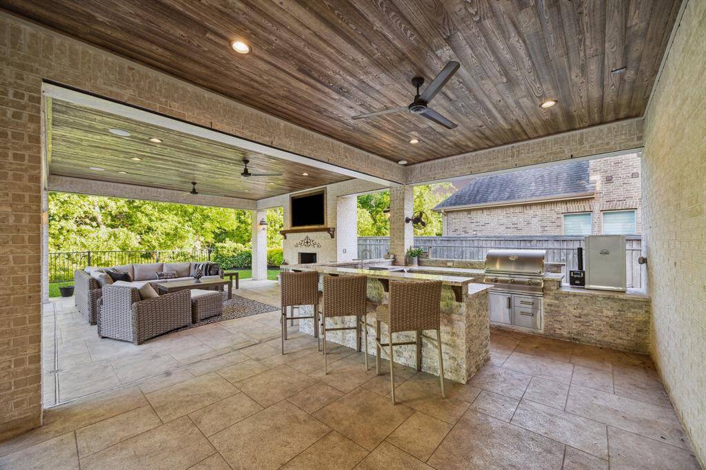 Whether you're hosting friends and family, or are just enjoying an evening with your favorite person, this stunning outdoor patio will have you covered. From the sitting area to the summer kitchen filled with Fire Magic appliances, there is sure to be space for anyone and everyone you have over!