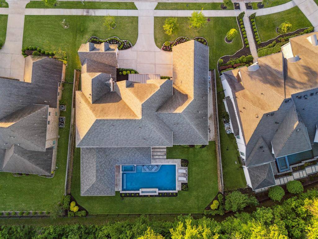With plenty of greenspace alongside your pool/spa, covered patio, summer kitchen, and dining area, you'll have plenty of room to play. Whether you're hosting lively gatherings or seeking tranquility after a long day, this incredibly spacious yard can handle it.