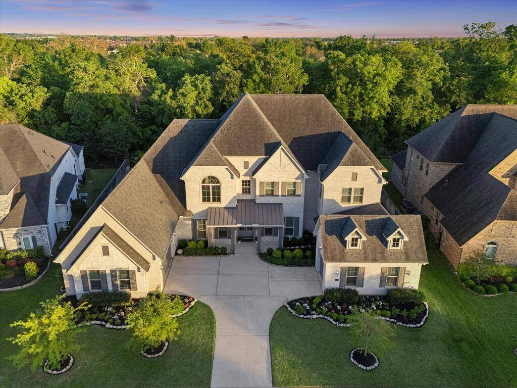 Discover the perfect balance of luxury, comfort, and privacy in this beautifully appointed 5-bedroom, 4.5-bath home. From soaring ceilings and a chef-inspired kitchen to a resort-style backyard with a heated and chilled pool, spa, and summer kitchen, every detail was designed for the way you live. Backing to a serene wooded area with no rear neighbors, this extraordinary home invites you to relax, entertain, and make lasting memories. Welcome home.