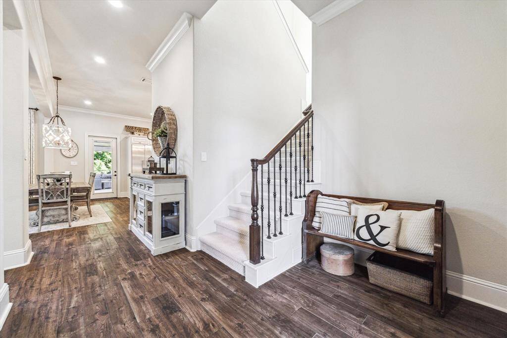 From the moment you enter, this home impresses with timeless elegance and upscale finishes. Wood-look tile flooring, soft neutral tones, refined millwork, and soaring ceilings with designer lighting and fans create a sophisticated ambiance throughout. Open, airy living spaces offer the perfect blend of everyday comfort and effortless entertaining in a truly luxurious setting.