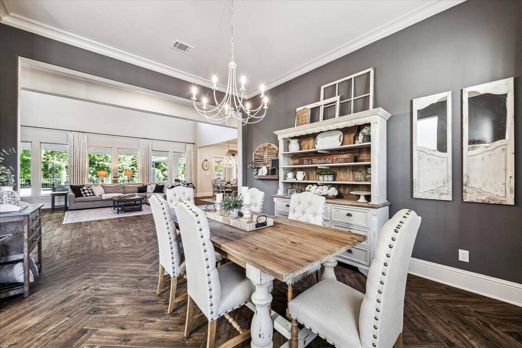 Gather them around your table to honor old traditions and create the new. Your friends and family will love gathering in this elegant formal dining room, featuring stunning wood-look tile flooring, designer paint, and tall windows with classic wood shutters that fill the space with natural light.