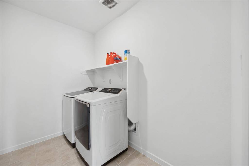 Laundry room is downstairs just off the living room. Samsung washer & dryer can also stay with the home. Extra storage next to the laundry room!