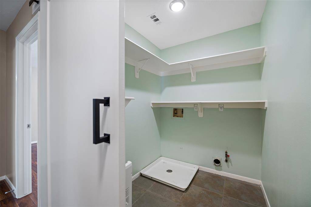 Laundry room with ample shelving for storage, perfect for organizing and simplifying chores.