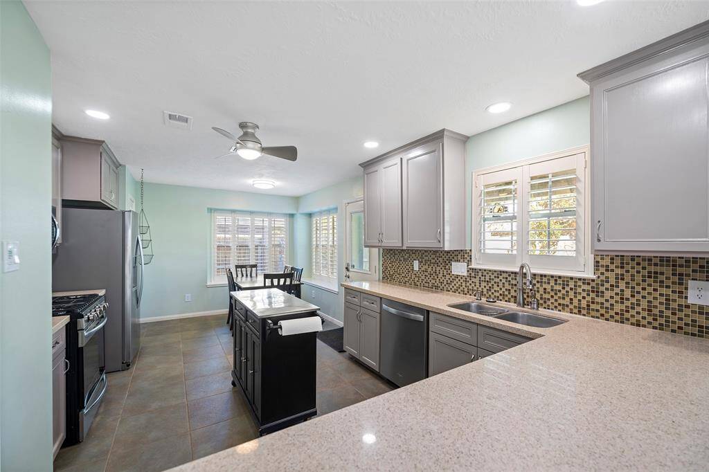 Experience modern living in this bright, open kitchen featuring quartz countertops, stainless steel appliances, and ample cabinet space. Enjoy meals in the cozy breakfast nook with abundant natural light.