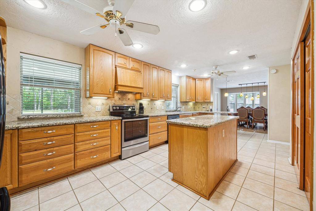 Spacious kitchen featuring a breakfast bar and central island.