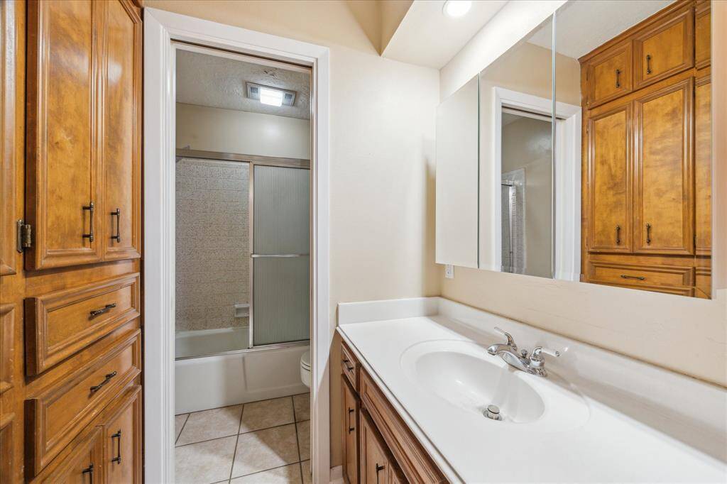 Convenient downstairs bathroom with ample storage and a sleek design.