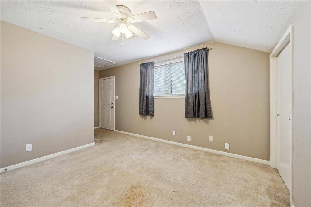 Spacious upstairs bedroom with a walk-in closet, accessible via a charming screened porch. Enjoy the convenience of two stairways for easy access.