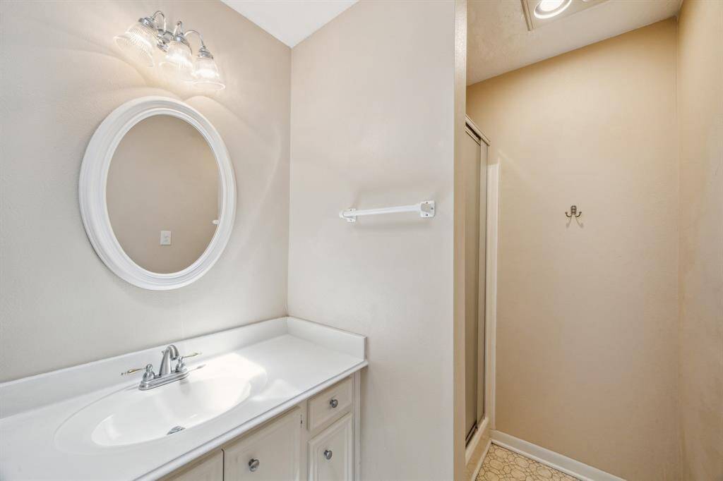 Bright upstairs bathroom with modern fixtures and a spacious shower.