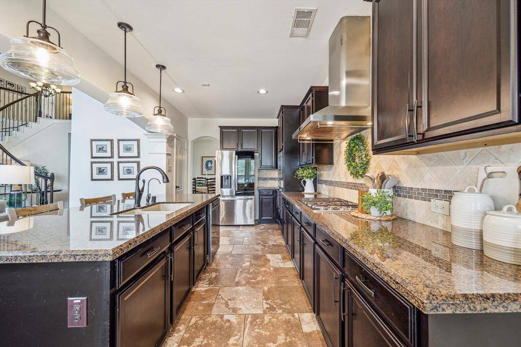 This fabulous island kitchen offers ample countertop space and cabinetry plus a large walk-in pantry. You'll have plenty of room for all your favorite kitchen gadgets here.