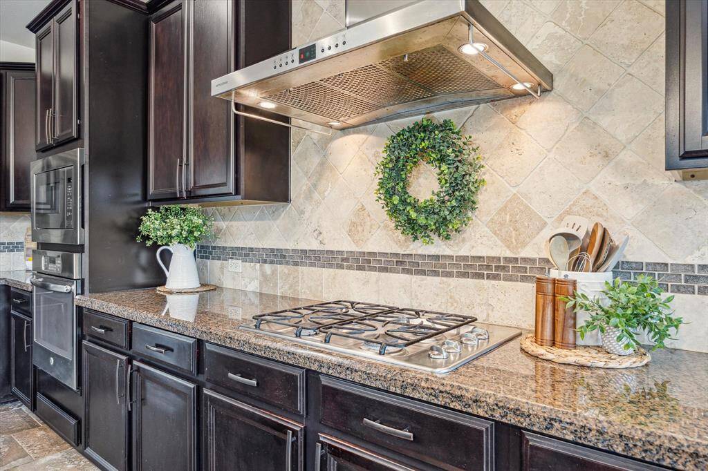 Ditch the takeout and fall in love with cooking all over again. This kitchen is as practical as it is beautiful, featuring modern stainless steel appliances including a built-in microwave, electric oven, gas cooktop with vent hood, and an automatic dishwasher all designed to make meal prep a snap.