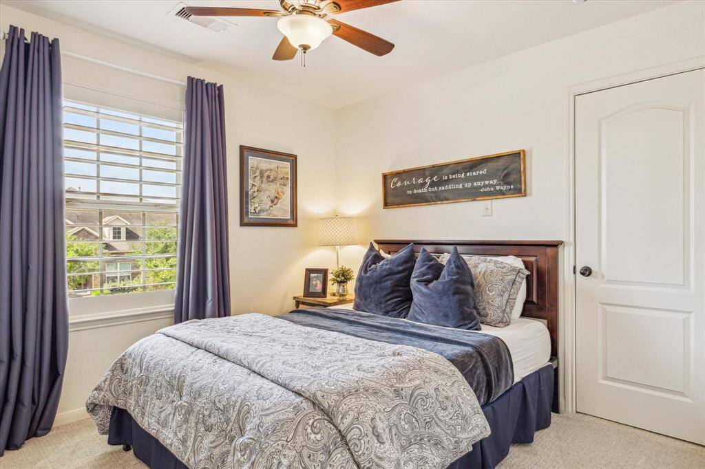 Your family and guests will rest comfortably in this roomy guest suite with plush carpet and neutral paint, wood shutters on the windows, a large walk-in closet and ensuite access to a full bathroom.