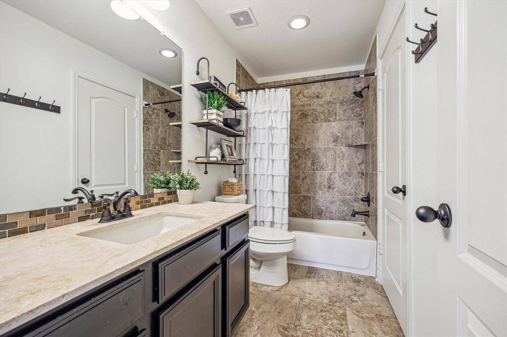 Morning routines should be relatively pain-free with two full bathrooms upstairs. This bathroom offers an extended single sink vanity with a full mirror and vanity lights above plus a convenient tub/shower enclosure.