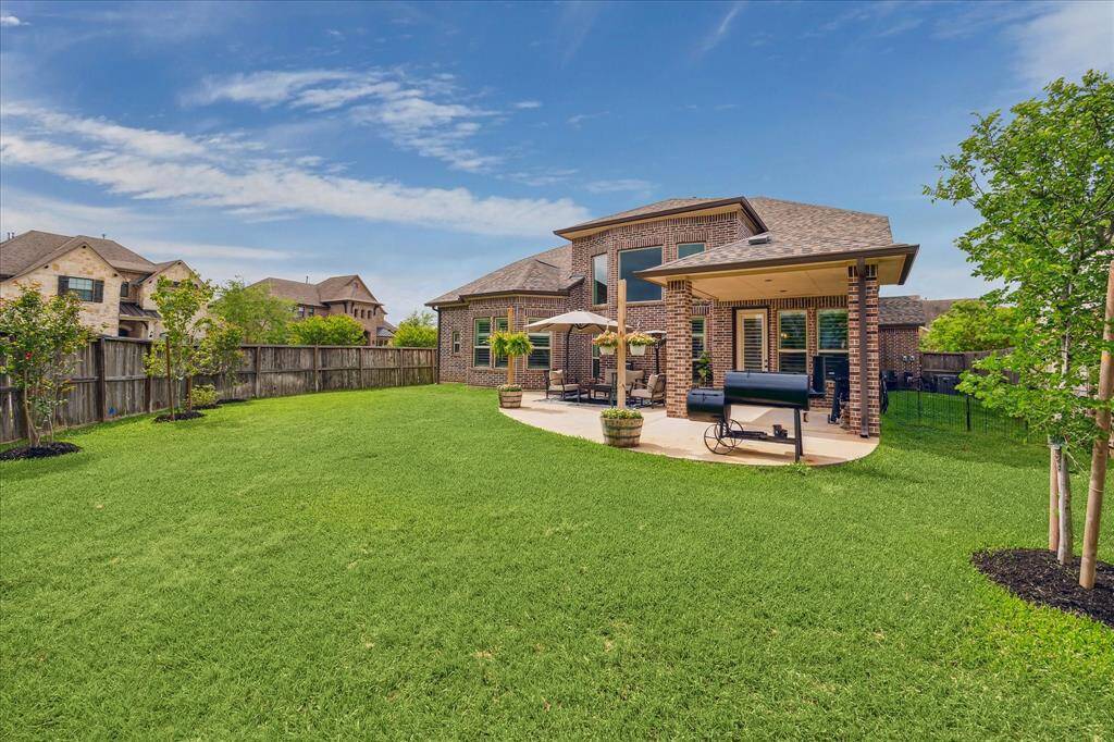 This charming covered patio is the perfect space to unwind and relax whether sipping morning coffee or dining al fresco with your favorite person.