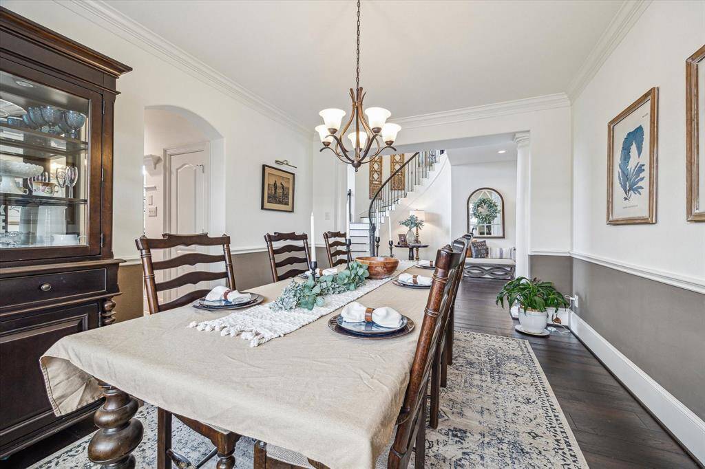 Your friends and family will love gathering in this elegant dining room, featuring designer paint, a chic chandelier, and a warm, inviting atmosphere perfect for sharing meals and making memories.