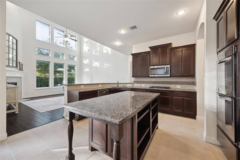 Large Island with Granite Countertop for Serving with More Storage and Space for Barstools