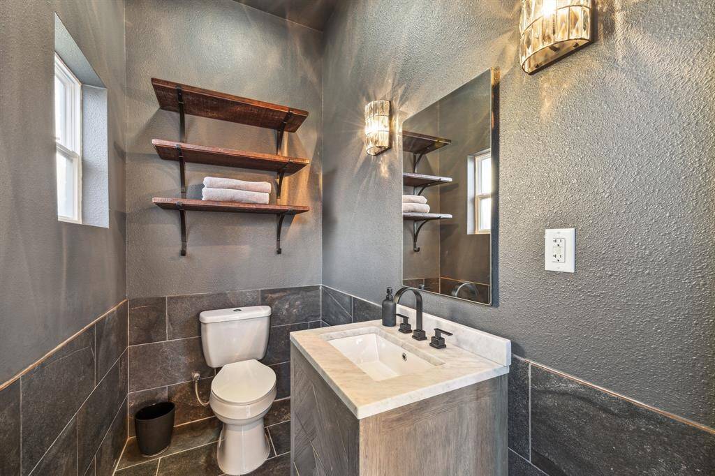 Not Your Standard Outdoor Pool Bath! This Lavish Pool Bath Features a Restoration Hardware White Herringbone Oak Vanity with Calcutta Marble, Tile Surround and Upscale Lighting & Fixtures!
