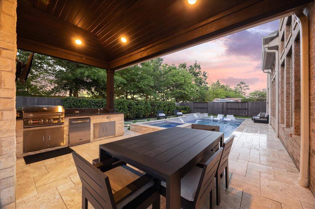 The Amazing Extended Outdoor Covered Patio w/ Cedar Ceiling, Can Lighting, Outdoor Kitchen and Travertine Pavers