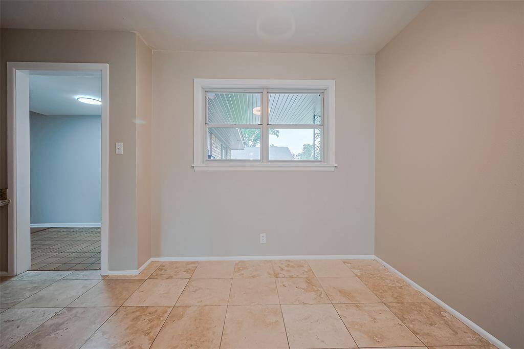 The breakfast nook has a window for natural light, tile floor and recent SW Accessible Beige Paint.