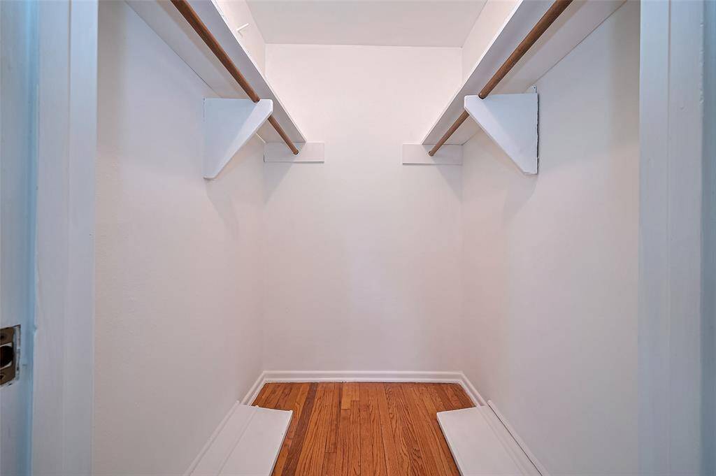 Primary walk in closet for all your trendy outfits and accessories.