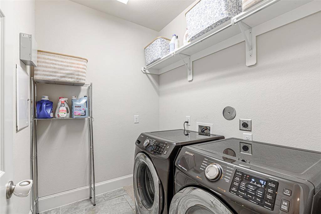Utility room with shelves above for added storage