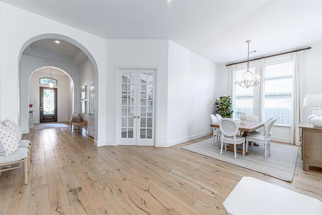 Gorgeous light wood floors reflect light and open the space