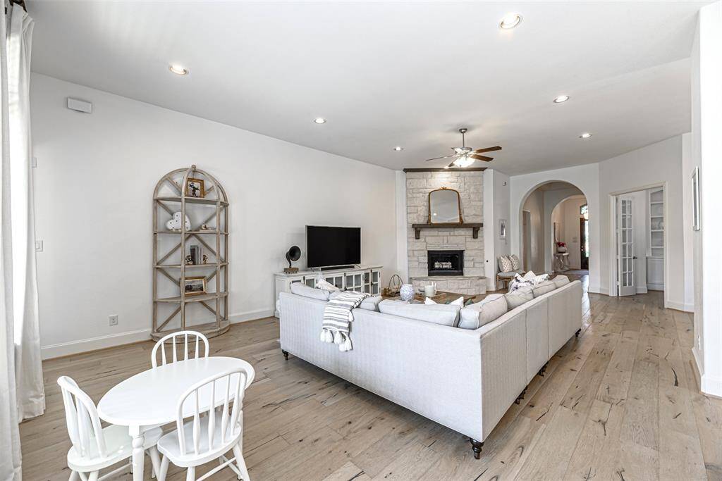 Long view of the family room with corridor and entry to the home office on the right