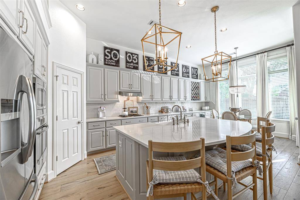View of the kitchen with upgraded lighting fixtures and plenty of cabinetry
