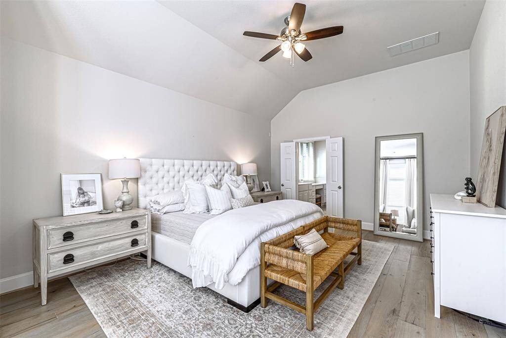 Primary bedroom with wooden flooring