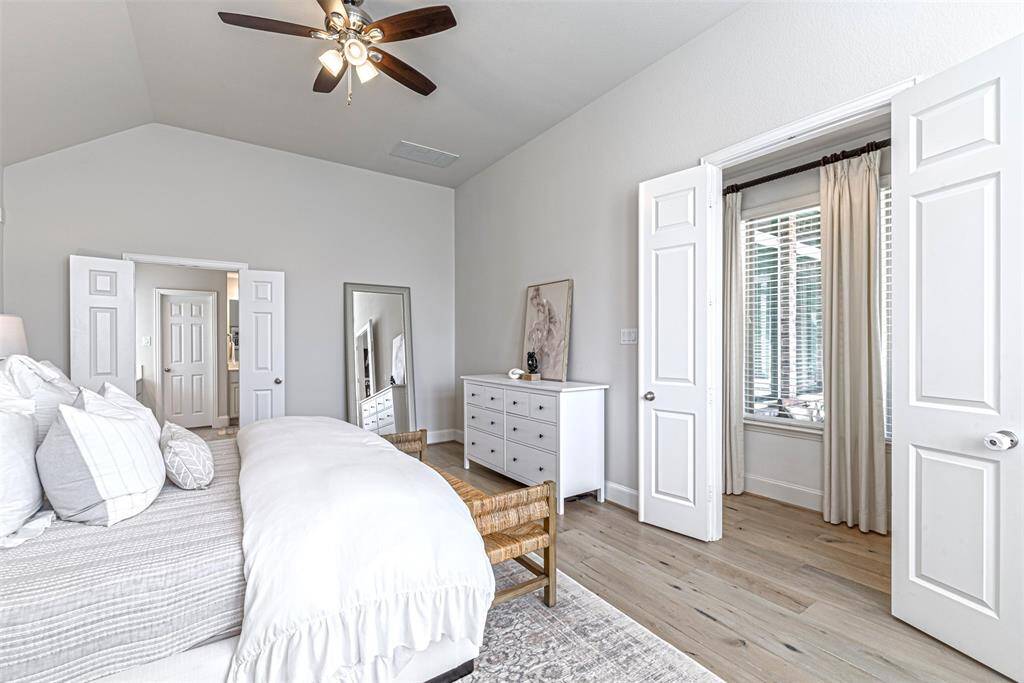 Wide primary bedroom with entrance to the bathroom on the left
