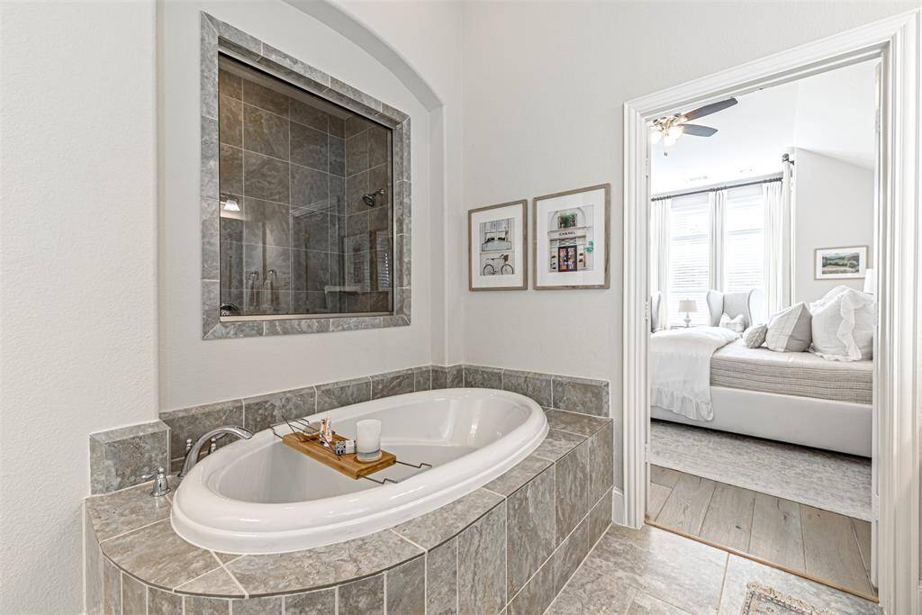 Soaking tub and stand up shower in the primary bathroom suite