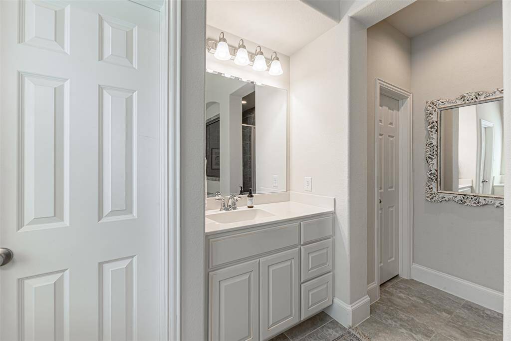 Second sink in the primary bathroom suite with door to the walk-in closet
