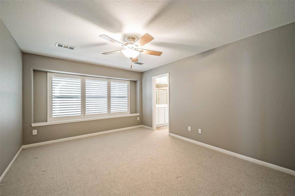 Master Bedroom is large with custom plantation shutters