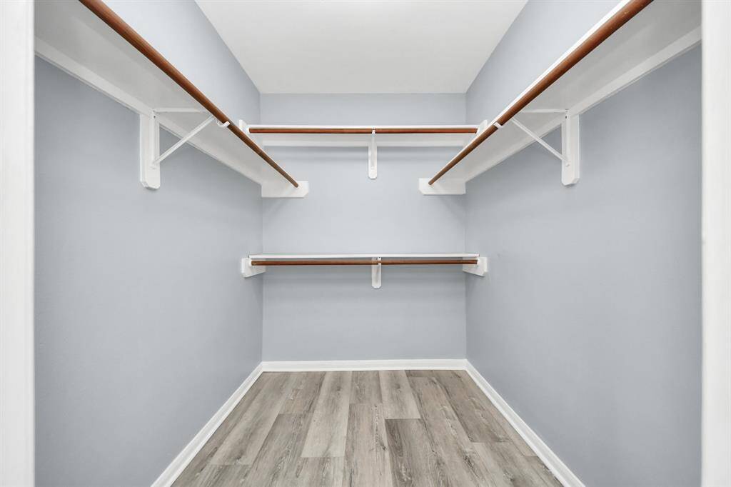 Primary bedroom has two closets this is only one of them