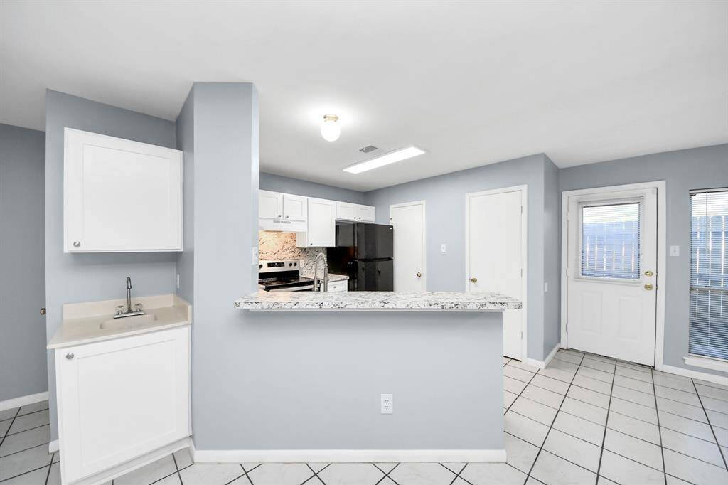Kitchen overlooks the living and dining areas