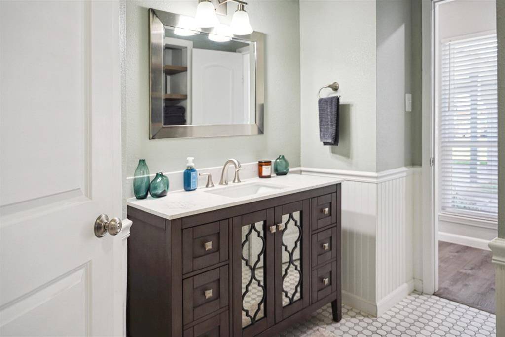 Bath – Stylish design featuring a soaking tub, modern tile, and double vanity.
