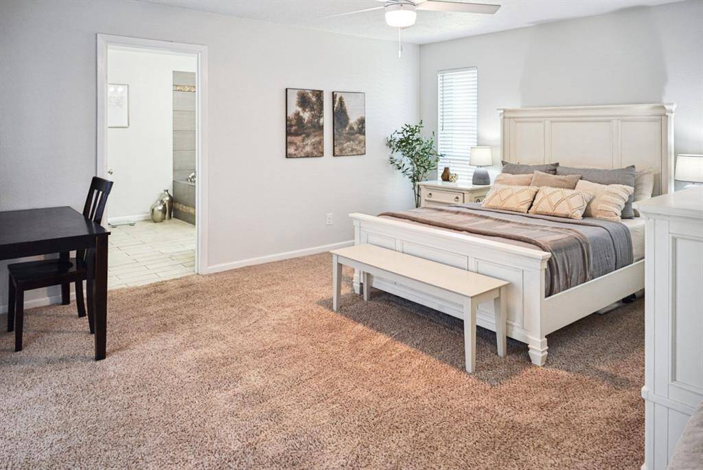 Primary Bedroom – Large and inviting, featuring neutral tones and plush carpet.