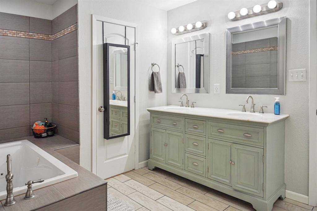 Primary Bathroom Vanity – Double sinks with ample storage and updated fixtures.