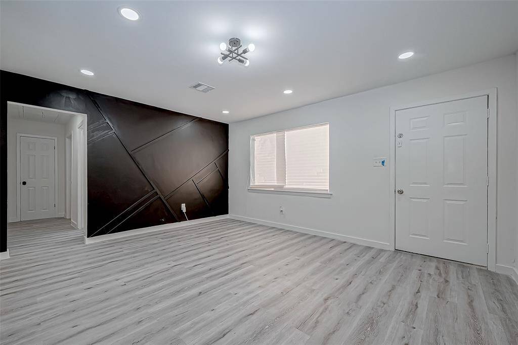 A door leading to the backyard adds convenience and encourages an effortless flow between indoor and outdoor living, making it ideal for hosting gatherings, enjoying quiet evenings, or simply stepping out to appreciate the fresh air.