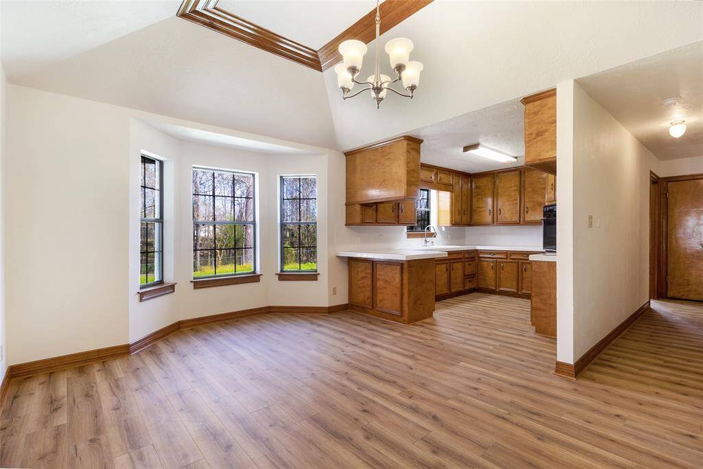 Dining to Kitchen - Breakfast Bar and Plenty of Cabinetry Storage