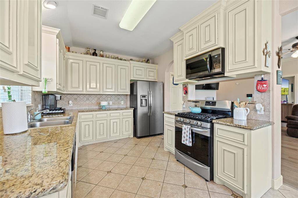Stainless steel appliances and granite countertops.